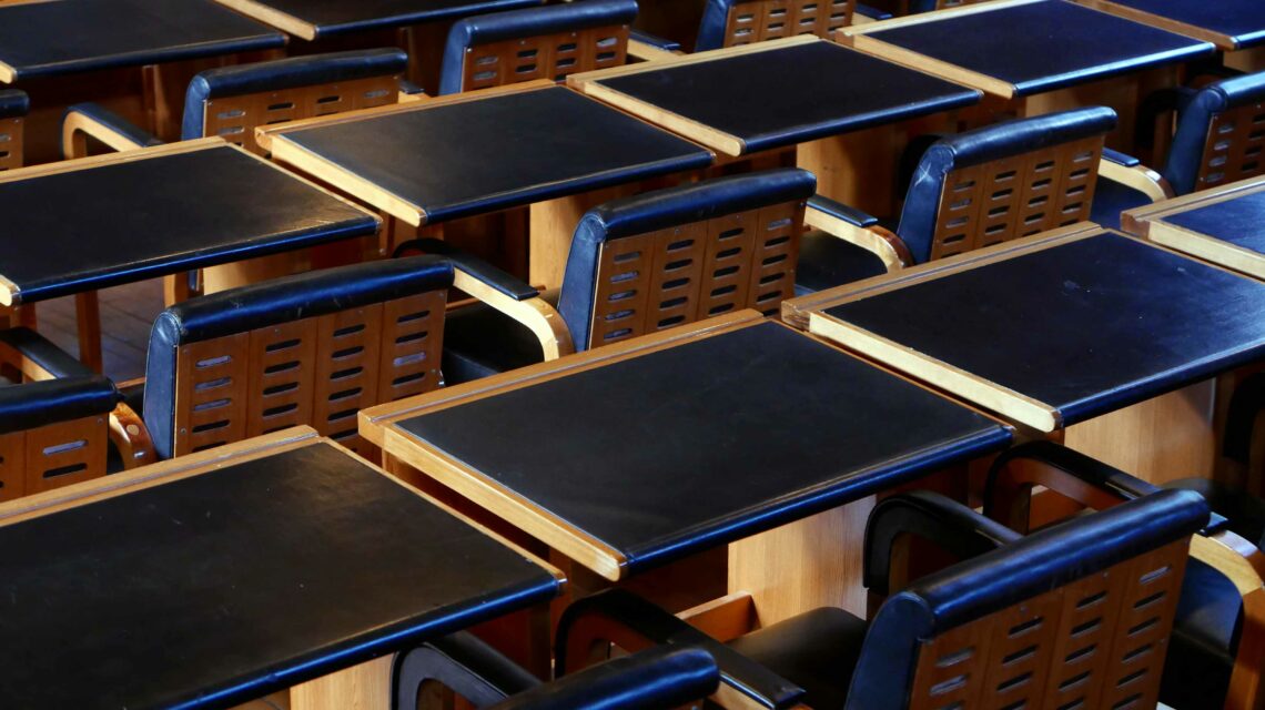 Upholstered, black leather-covered chairs and black desktops in the Councelours' Chamber in the Säynätsalo Town Hall designed by Alvar Aalto in 1949–52.